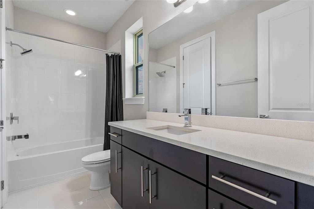 View of guest bedroom one en suite bath.