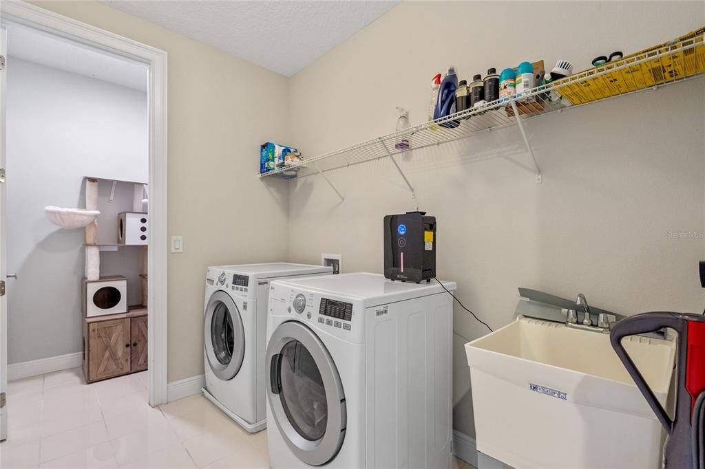 View of second floor laundry room and storage space.