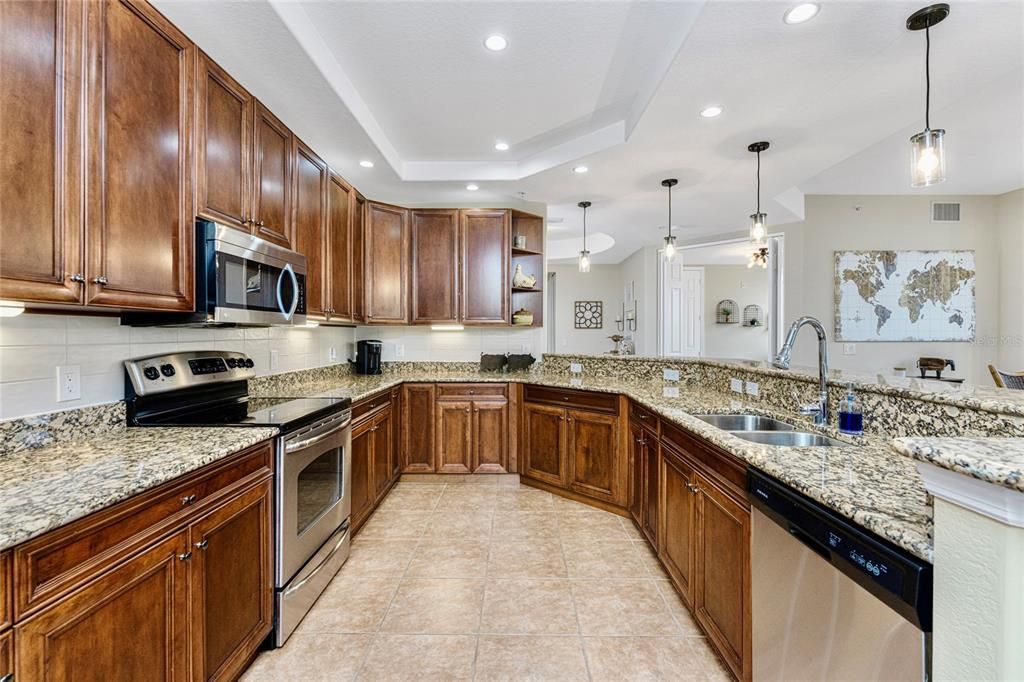 The kitchen is beautifully finished with plenty of cabinets designed to store you dinnerware, casual dinnerware, all your favorite appliances, enhanced with pendent lighting and custome tray ceiling and subway backsplash