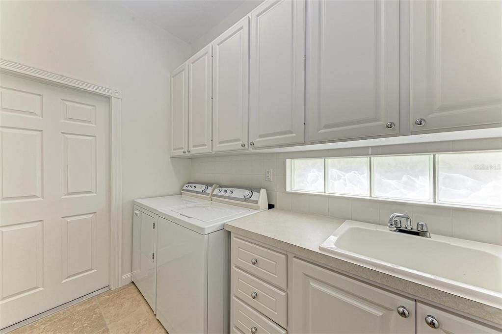 Laundry Room with plenty of storage cabinets and storage is located just off of the garage, so no need to track in messy shoes!