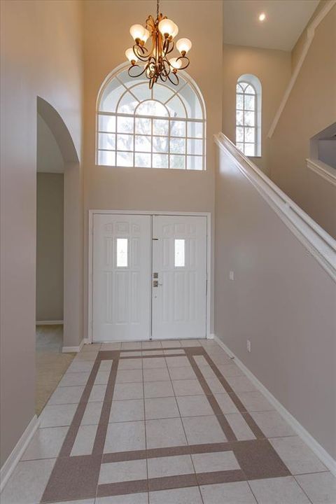 Soaring ceilings and double front doors in the foyer