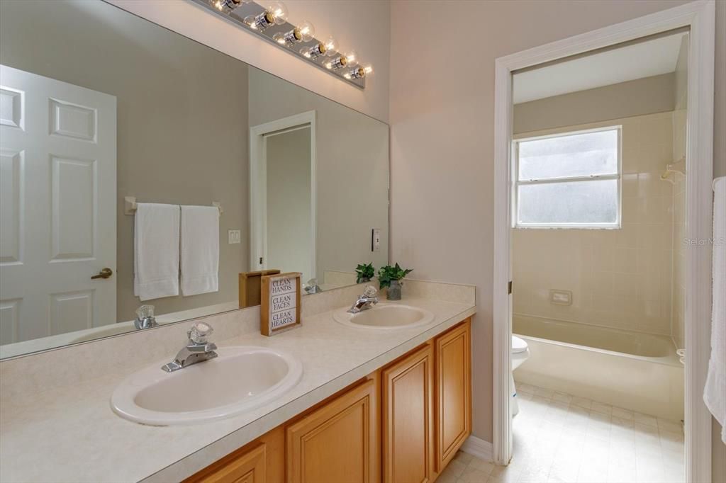 Bathroom 2 features dual sinks and pocket door