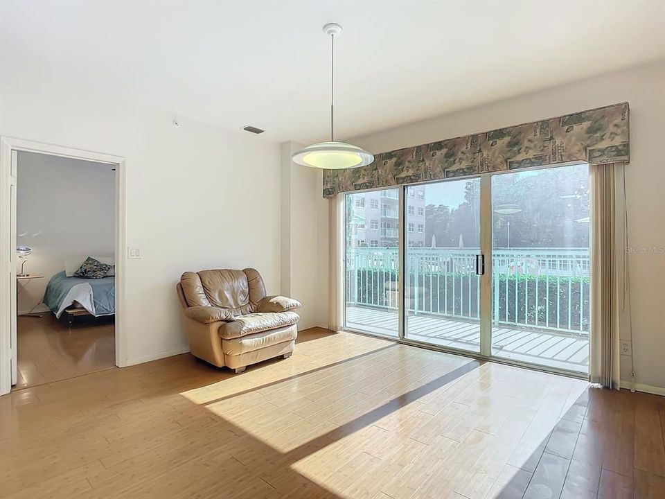 living room has sliding doors overlooking the pool