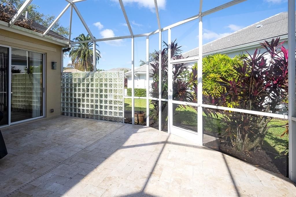 Large lanai with new travertine tile.