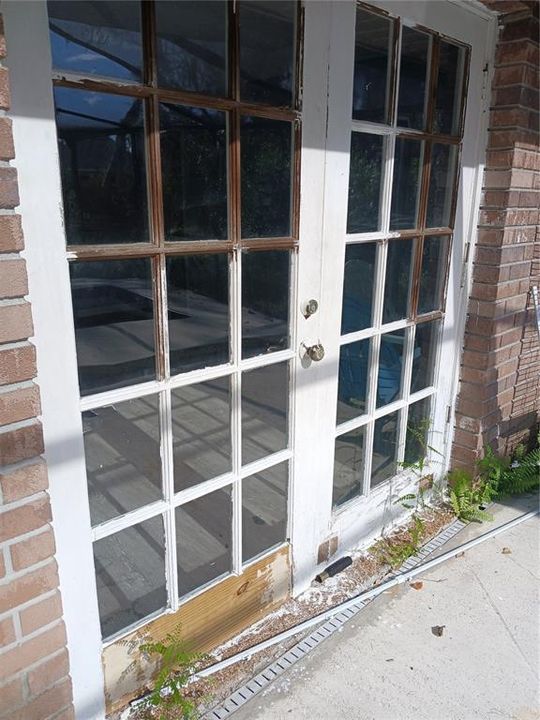 French doors from the primary bedroom to the pool area.