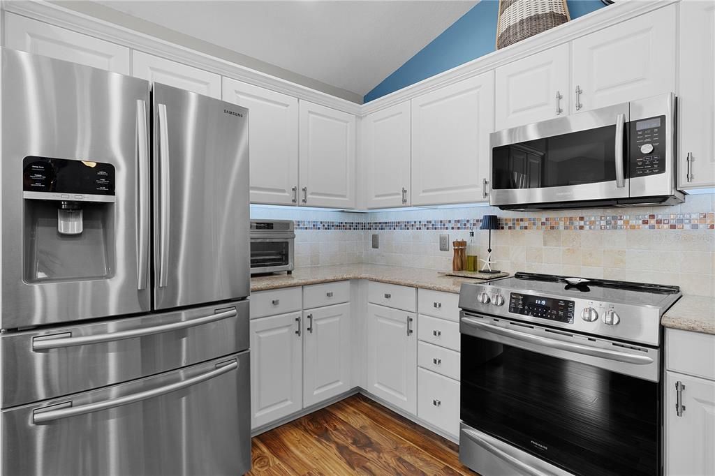 Stainless Steel Appliances, and Stylish tile backsplash