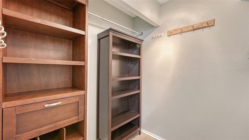 Primary bedroom closet has custom built-ins.