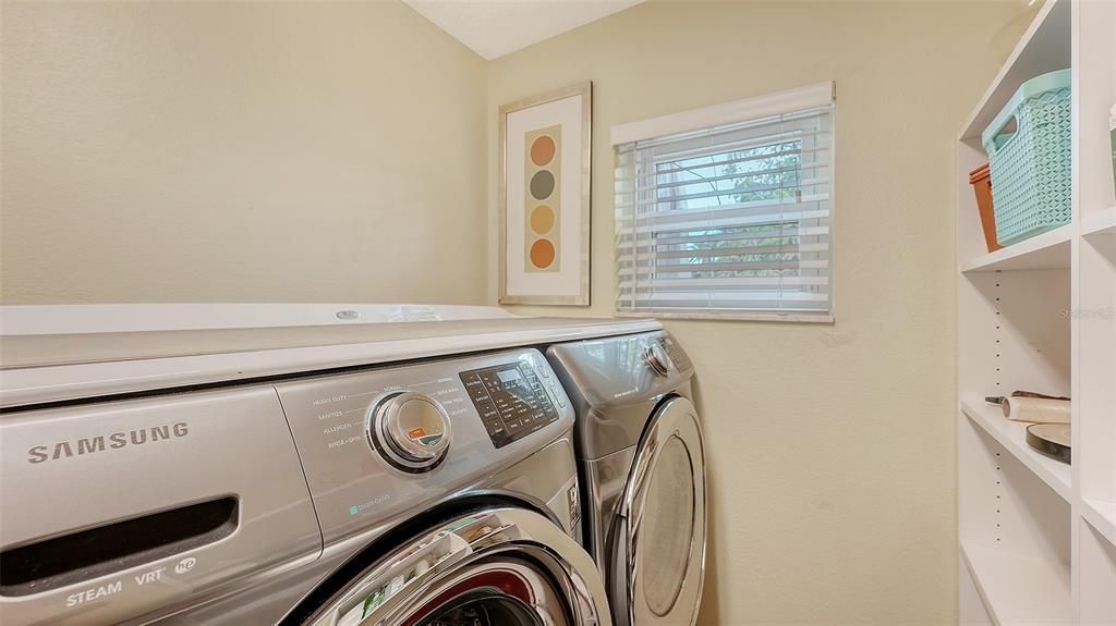 spacious utility room complete with front loading washer and dryer