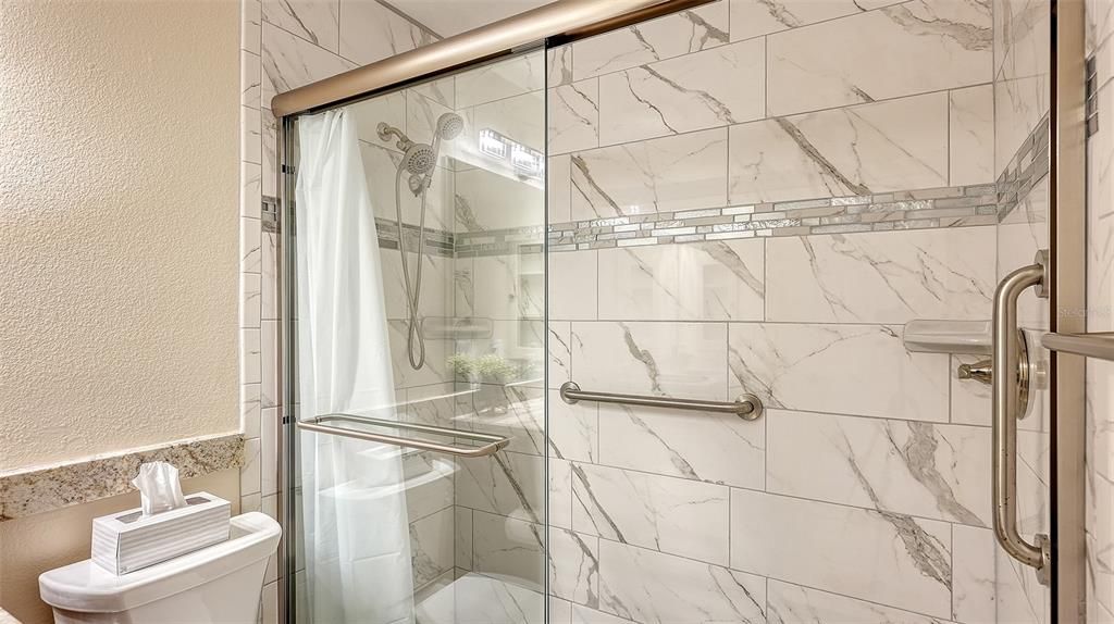 Beautiful guest shower with sliding glass door