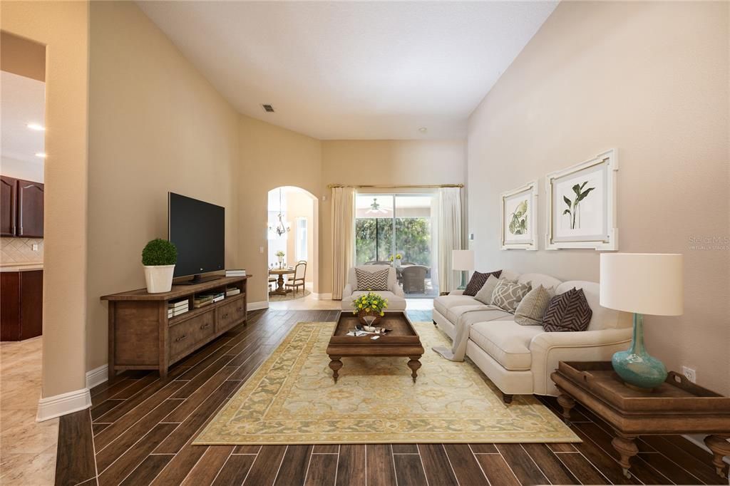 Start your tour in the light and bright foyer open to both a formal dining space and a living room complete with sliding glass door access to the SCREENED LANAI.  Virtually Staged.