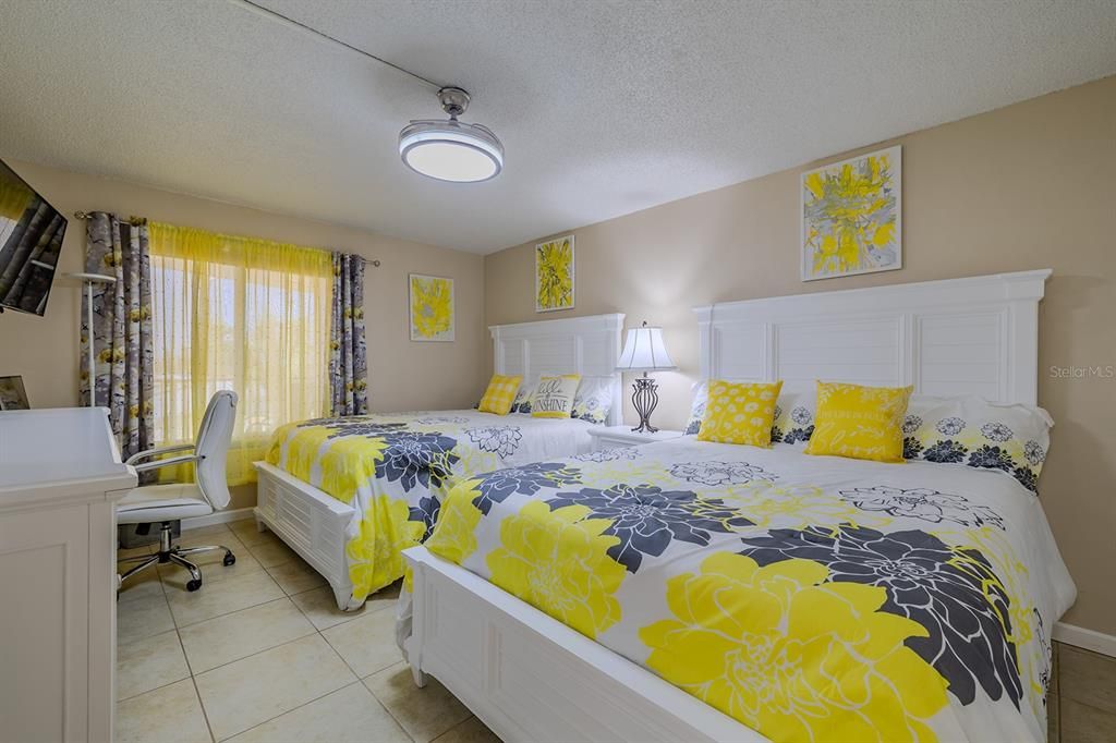 Spacious guest bedroom can easily accommodate 2 queen beds