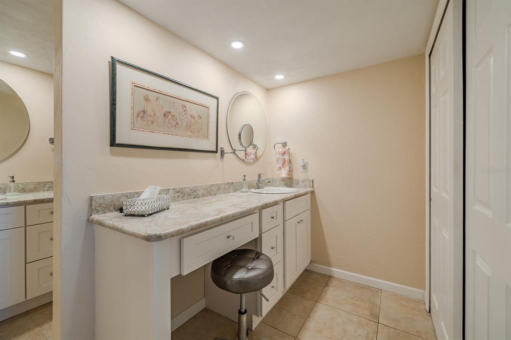 Primary suite has dressing area and second vanity with sink