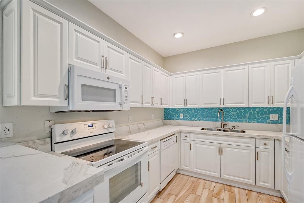 Quartz Countertop with Lots of Cupboard Storage and Vibrant Backsplash