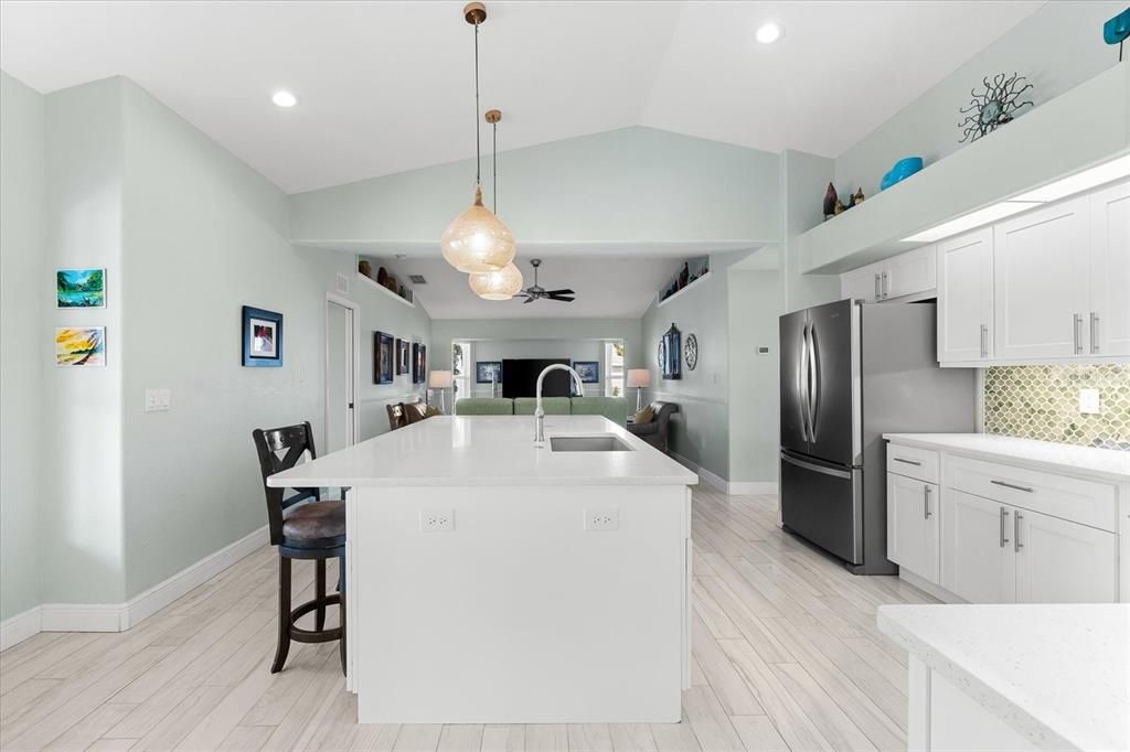 Modern Kitchen Featuring an Expansive Quartz Island