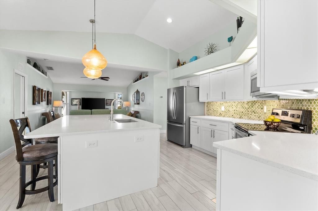 Modern Kitchen Featuring an Expansive Quartz Island