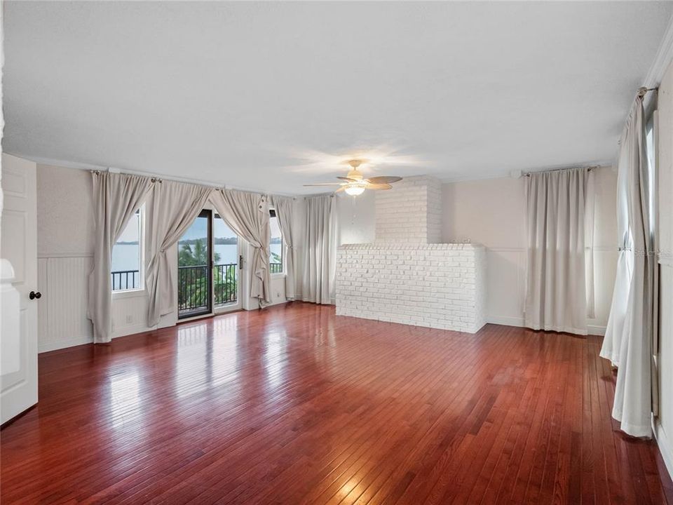 Primary Bedroom with private balcony overlooking lake and pool