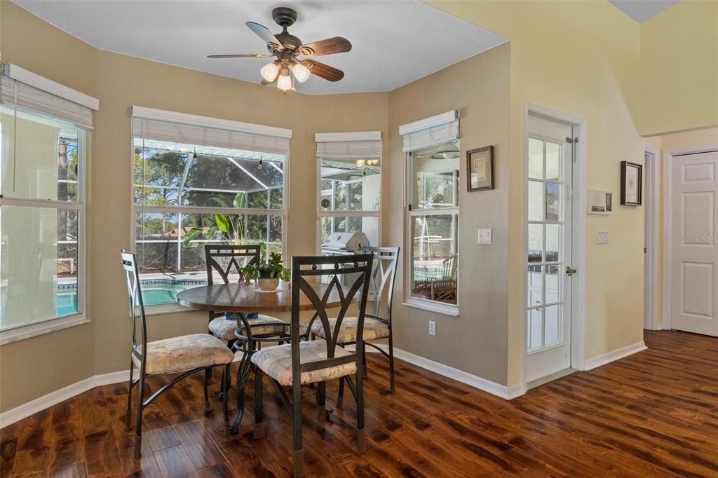 The breakfast nook, just off the kitchen, features a bay window overlooking the lanai, pool, and golf course. Perfect for morning coffee and casual meals.