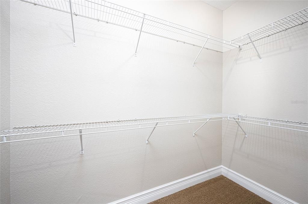 Primary bedroom walk-in closet