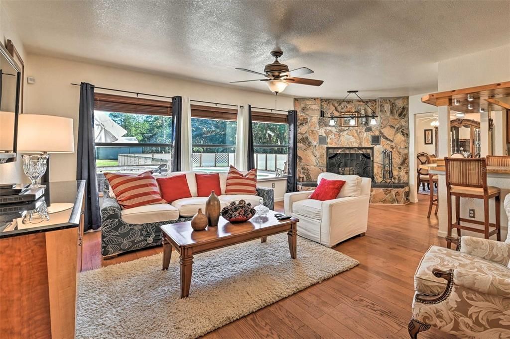 Open & Airy living area flooded with natural lighting and working fireplace