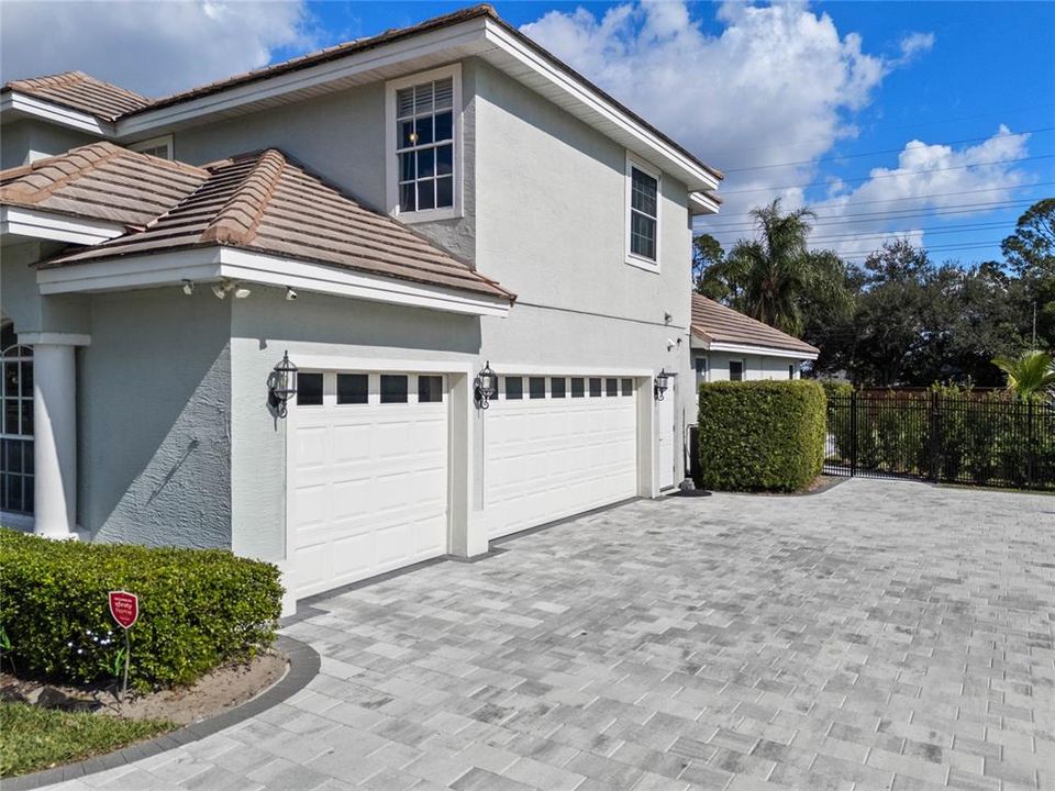 Three car garage and paver driveway