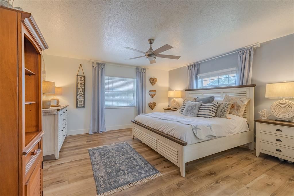 Primary bedroom with King bed shown & walk-in closet