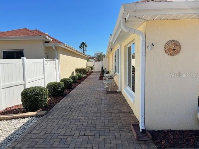 Paved walkway from front of house to rear