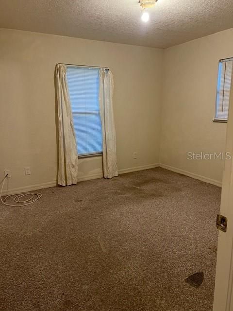 Master suite with attached  half-bath overlooking the shaded back yard.