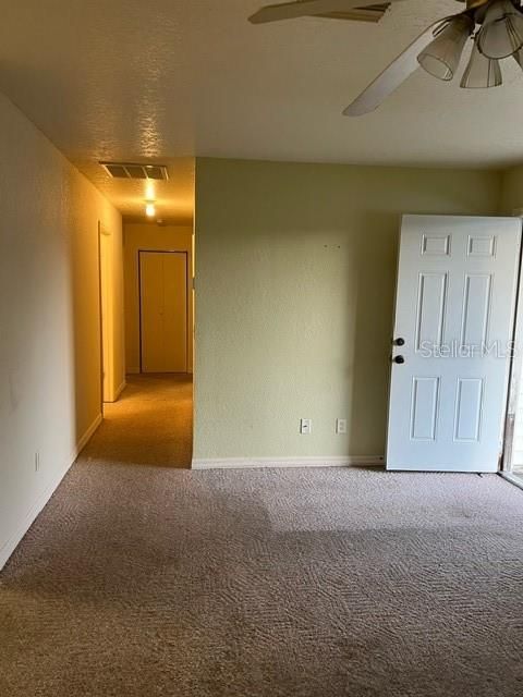 Living area looking down the hall toward the bedrooms and linen closet at the end of the hall.