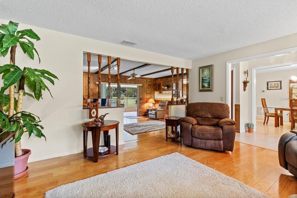 Formal Living Room w/ Colonial Spindled Half Wall Separating the Family Room