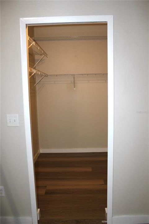 Primary bedroom walk in closet