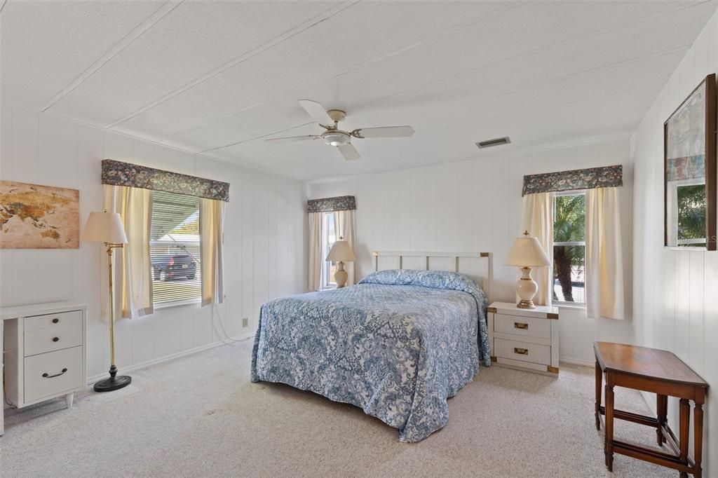 Large primary bedroom with an abundance of natural light