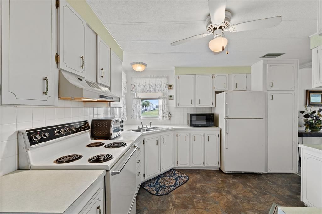 Kitchen has an plenty of cabinets and view of lake from sink window