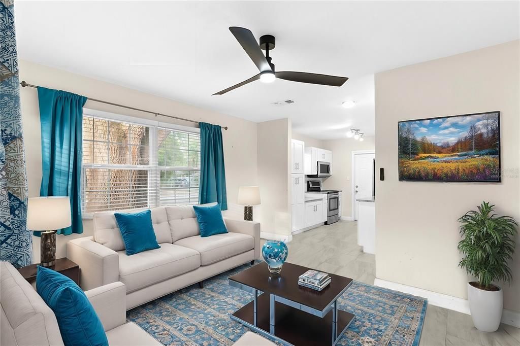 Nice size living room open to the kitchen virtually staged