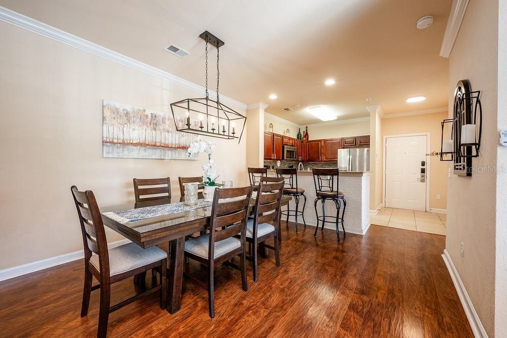 The covered entry opens up to a spacious flowing floor plan with an upgraded kitchen, open living and dining areas all finished with crown molding and modern light fixtures.