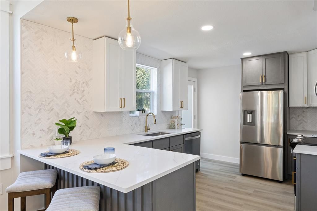 This kitchen has it all new appliances, fresh paint, new flooring, &  new cabinets with gold hardware.