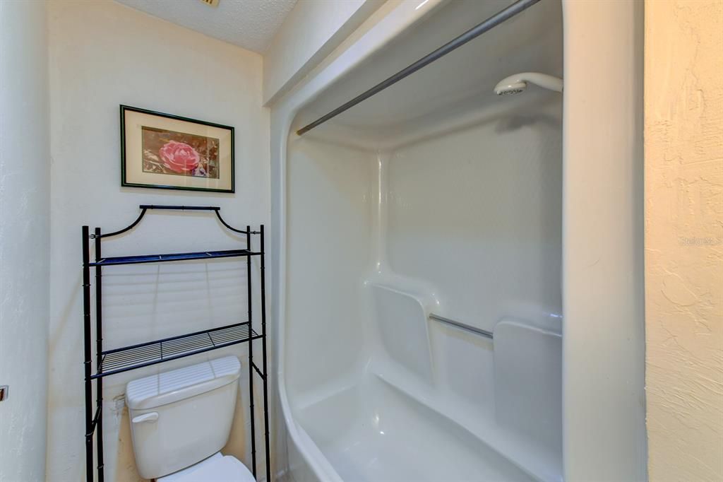 The guest bathroom features a tub shower