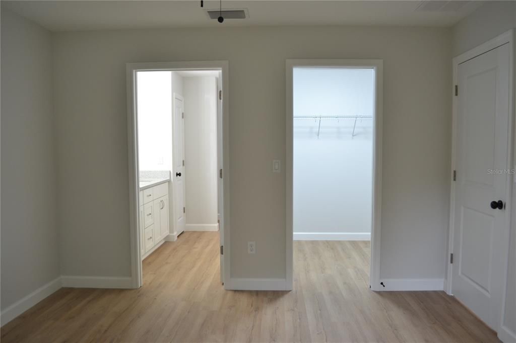 PRIMARY WALK-IN CLOSET AND BATHROOM ENTRY