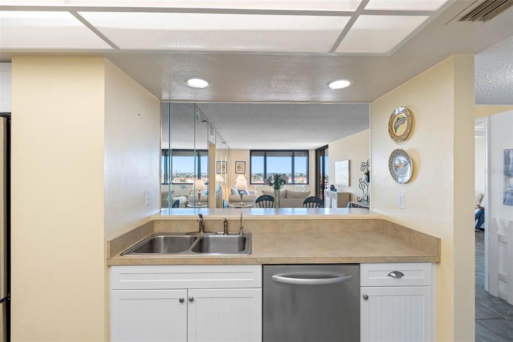 This chef-inspired kitchen features stainless steel appliances, white cabinetry, and a breakfast bar perfect for entertaining.