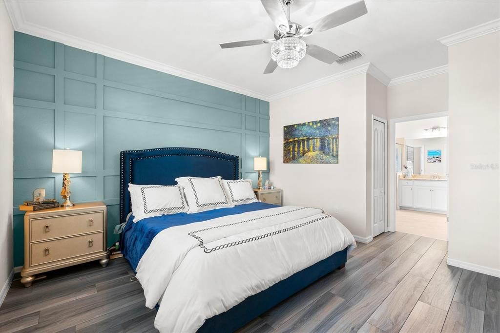 Primary Bedroom with flooring and upgraded ceiling fan.