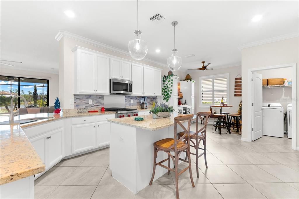 Spacious kitchen with custom wine area and laundry room.