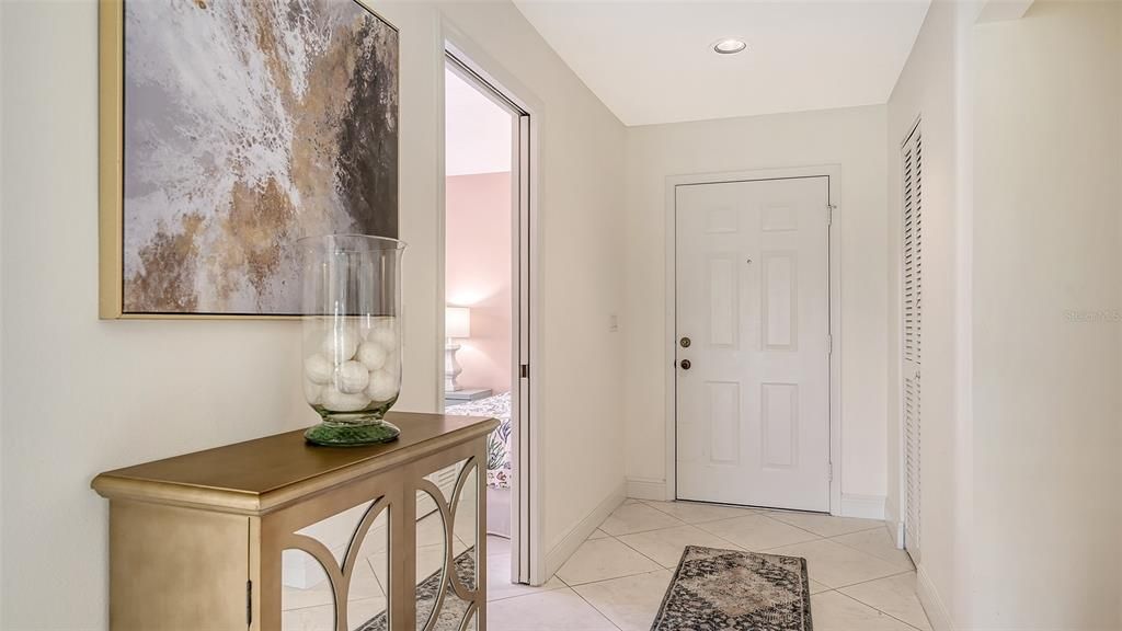 Large foyer with 18" tile flooring laid on the diagonal and closet