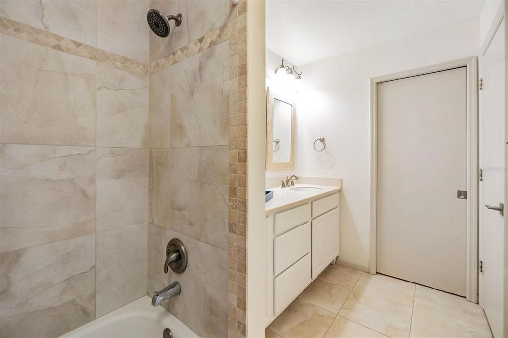 Second bathroom with beautiful tub/shower large vanity and second entry door in second bedroom