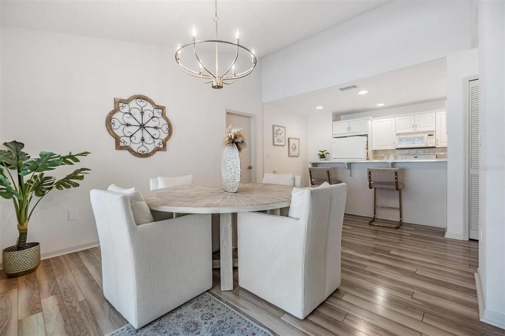 Kitchen overlooks the formal dining room with views out the glass sliders to the pool