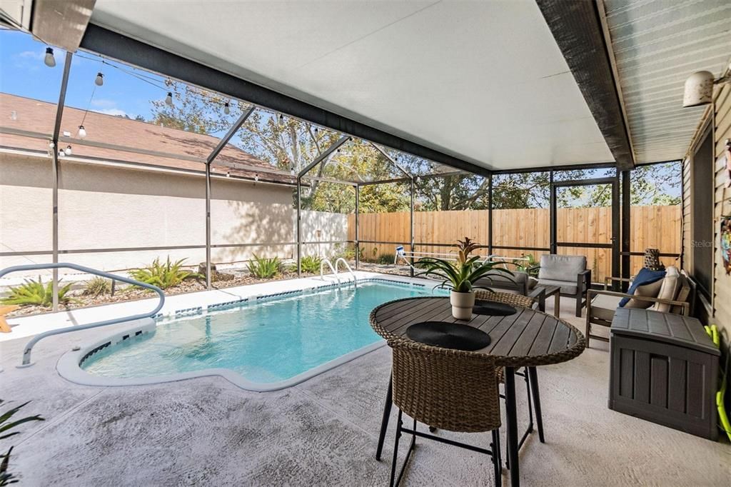 Covered sitting area of pool deck for cozy outdoor living space