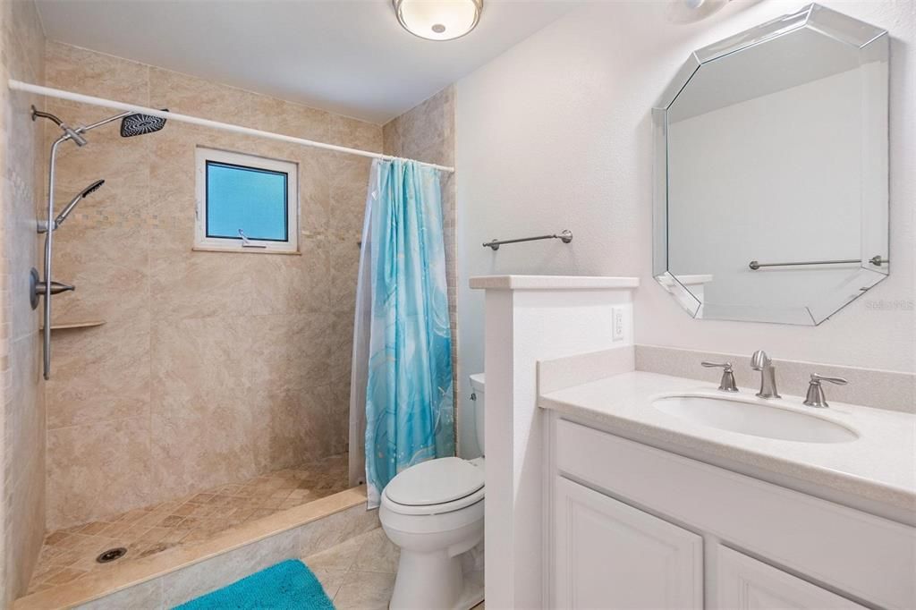 Primary ensuite bathroom with large double sink vanity, and stand-up shower