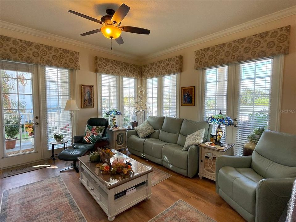 Bright living area with multiple French doors to balcony