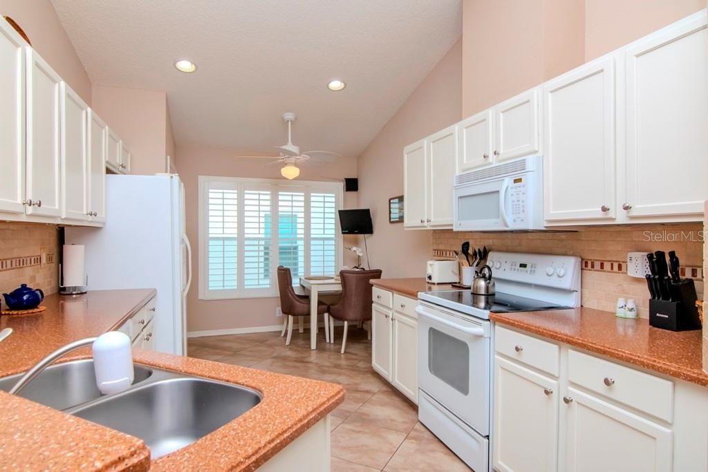 Eat-in Kitchen. Breakfast Bar, Newer tile floors, updated cabinets, solid surface countertops