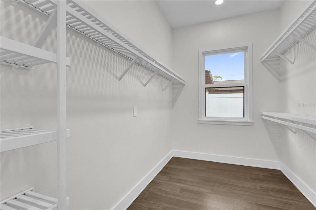 Large primary closet with shelving in place