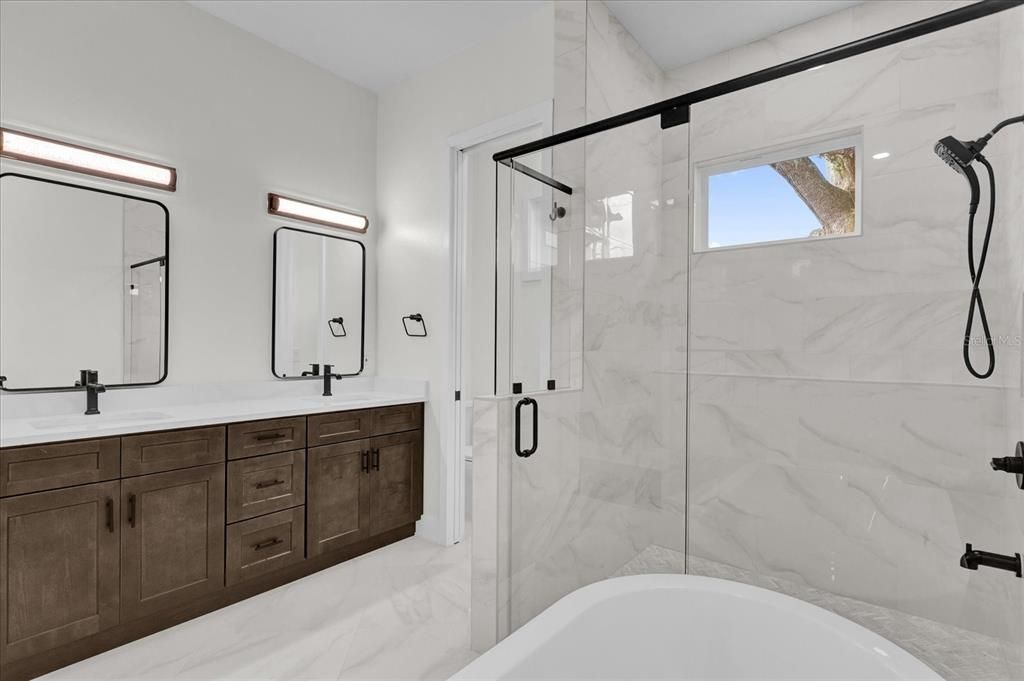 Large separate shower and private commode in primary bathroom