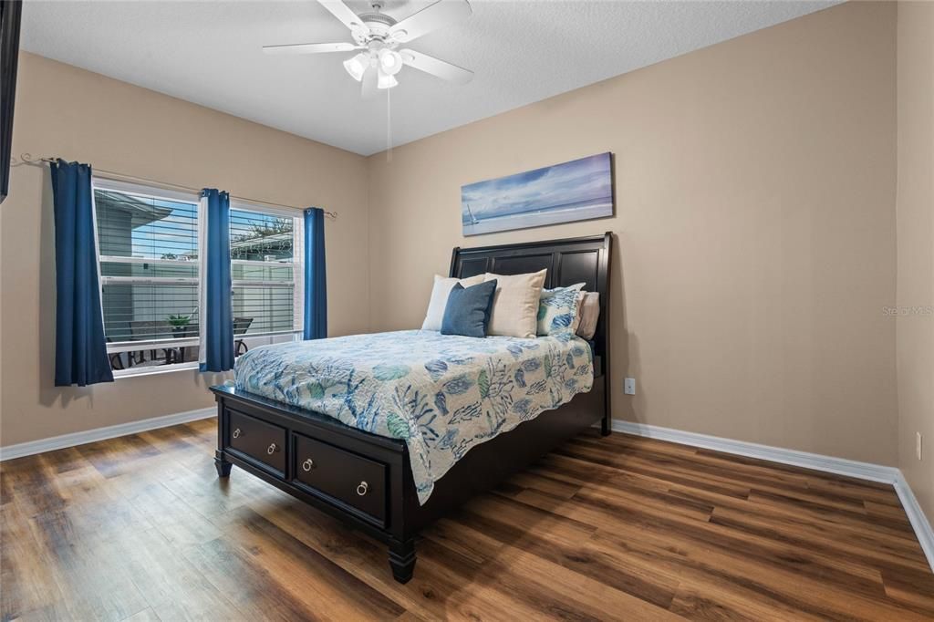 Primary bedroom overlooks private fenced patio